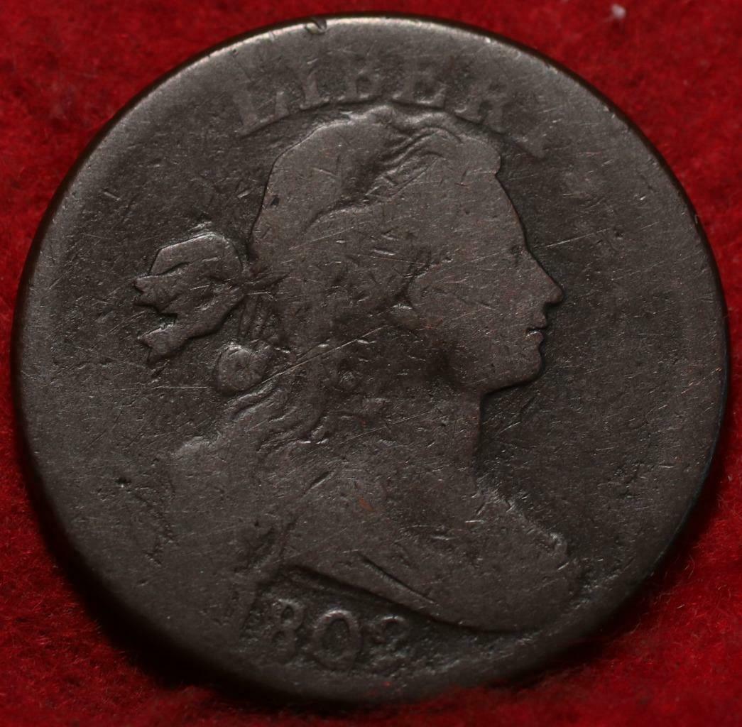Vintage coin with a profile of a woman on a red background