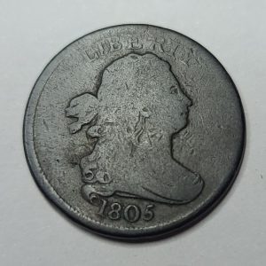 Vintage coin with a profile of a person and '1805' on a gray background