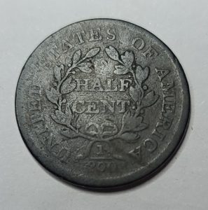 Old coin with 'Half Cent' text on a light gray background