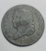 Old coin with a profile silhouette and '1825' marking on a gray background