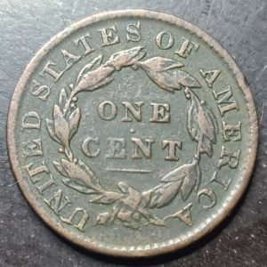 One cent coin from the United States with 'One Cent' text on a dark background