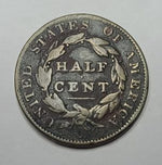 Half cent coin from the United States of America on a gray background