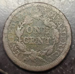 Old coin with 'One Cent' text on a dark background