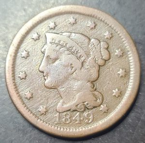 coin with a profile of a woman and the year 1849 on a gray background
