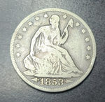 Silver coin with '1853' on a dark background