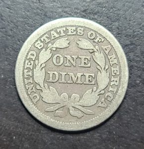 Silver dime coin with 'United States of America One Dime' text on a dark background