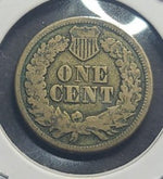 Vintage one cent coin with a shield design on a reflective surface