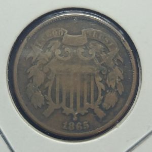 Vintage coin with an eagle emblem and '1865' on a white background