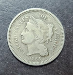 coin with a profile of a woman and 'Liberty' text on a dark surface