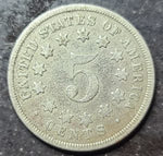 Silver five-cent piece from the United States with star designs on a dark background
