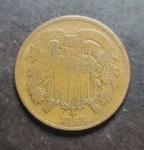 Close up of an 1868 2 cent piece obverse 