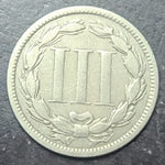 coin with embossed design on a dark background