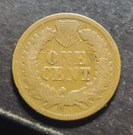 coin with 'One Cent' text on a dark surface