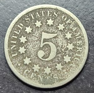 Five-cent piece coin from the United States on a dark background