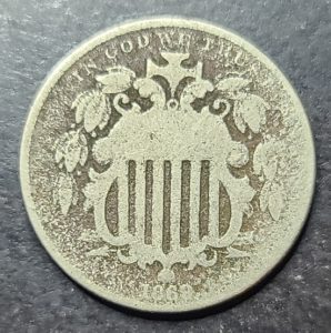Vintage coin with intricate design on a dark background
