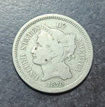 coin with a profile of a person and '1870' on a dark surface