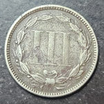 Coin with a detailed design on a dark surface