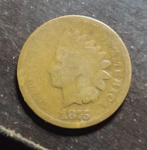 Vintage Indian Head penny on a dark surface