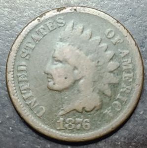 Vintage U.S. coin with a profile of a Indian and '1876' on a dark background