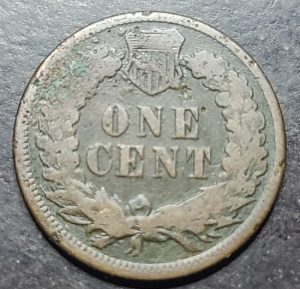 Vintage one cent coin with 'ONE CENT' text on a dark background