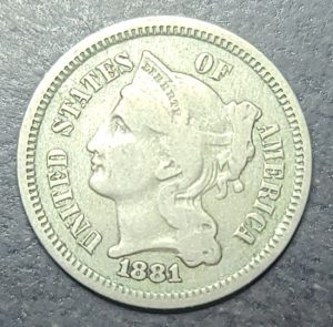 Close up of a 1881 3 cent nickel 