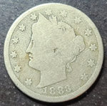 Vintage silver coin with profile of a woman and date 1883 on a dark background