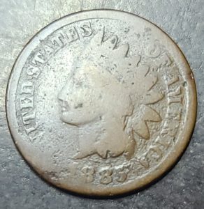 Vintage U.S. coin with a portrait and date on a metallic surface