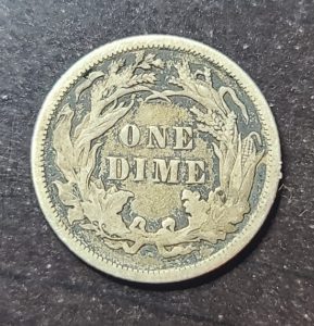 Vintage one dime coin on a dark background