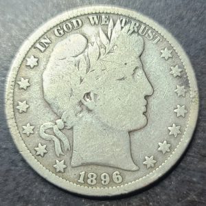 Silver coin with 'In God We Trust' and '1896' on a dark background