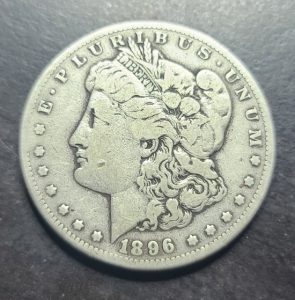 Silver Morgan dollar coin from 1896 on a dark background