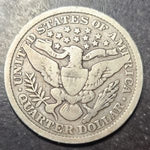 Silver quarter dollar coin with an eagle design on a dark background
