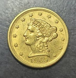 Gold coin with a profile of a woman and the year 1905 on a dark surface