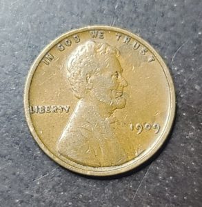 1909 Lincoln penny on a dark surface