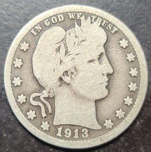Silver Barber quarter coin from 1913 with 'In God We Trust' and profile of Liberty.