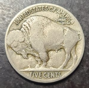 Buffalo Nickel coin on a dark textured background