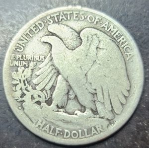Silver half dollar coin with eagle design on a dark background