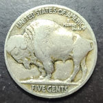 Buffalo nickel coin with a bison design on a dark background