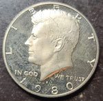 Kennedy Half Dollar coin with 'In God We Trust' inscription on a dark background