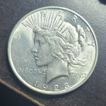 Silver coin with a profile of a woman and 'Liberty' text on a dark background
