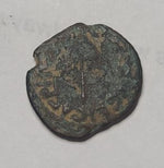 Bronze coin with engraved text on a gray background