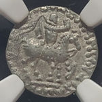 Silver ancient coin with intricate design on a white background