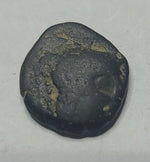Ancient coin with a portrait on a light gray background
