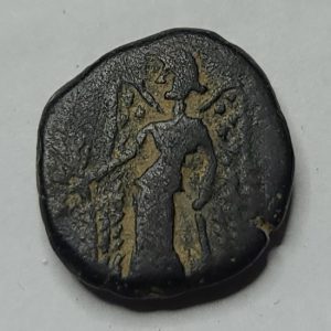 Ancient coin with a figure on a gray background