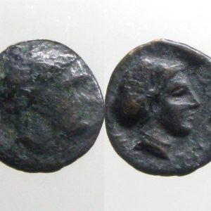 ancient coin with profiles on a white background