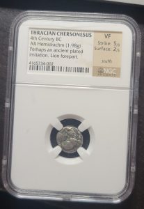 Ancient coin in a protective case with NGC certification label